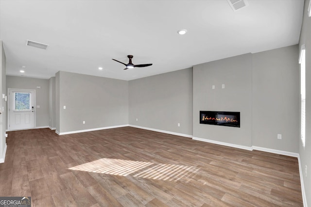 unfurnished living room featuring ceiling fan and light hardwood / wood-style flooring