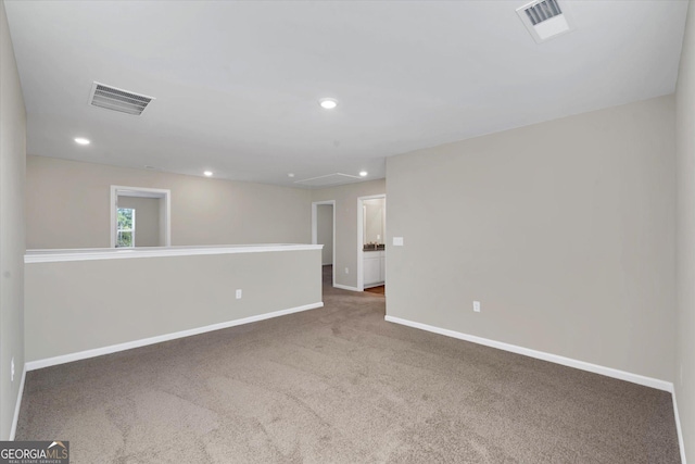 spare room with dark colored carpet