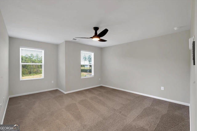 spare room featuring carpet and ceiling fan