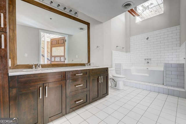 bathroom with tile patterned flooring, plenty of natural light, toilet, a bathtub, and vanity