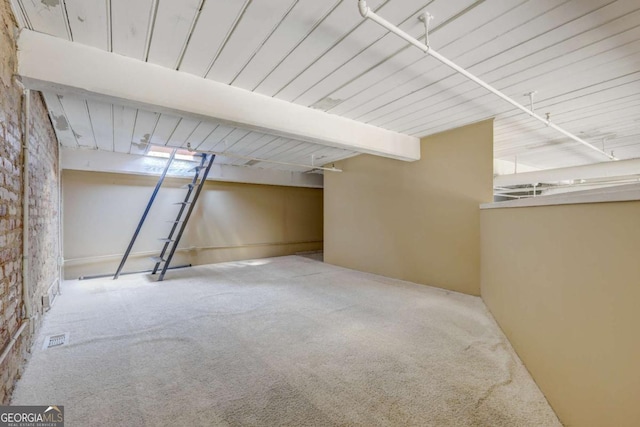 basement with carpet floors and brick wall