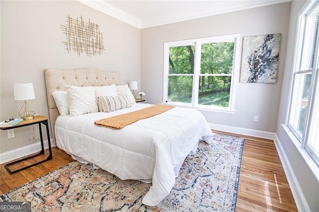 bedroom featuring hardwood / wood-style floors and ornamental molding