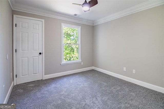 spare room with crown molding, carpet floors, and ceiling fan