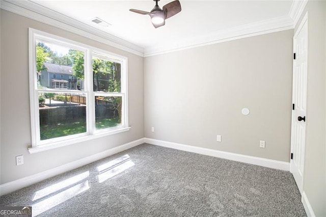 empty room featuring carpet flooring, ceiling fan, and crown molding