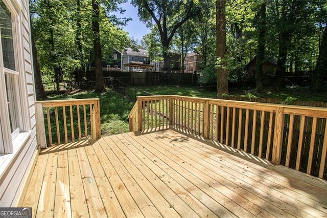 wooden deck featuring a yard