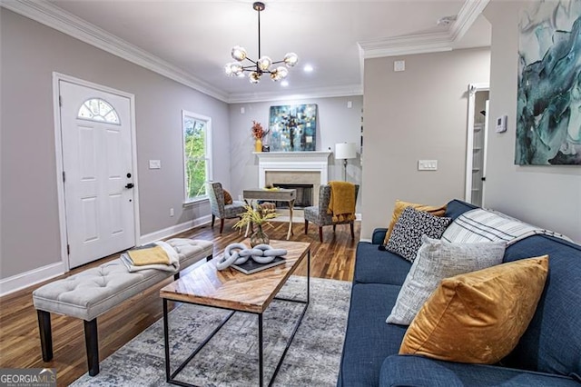 living room featuring hardwood / wood-style flooring, an inviting chandelier, and ornamental molding