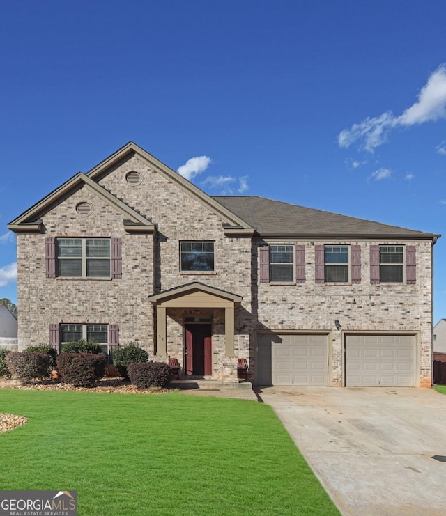 view of front of house with a garage and a front lawn