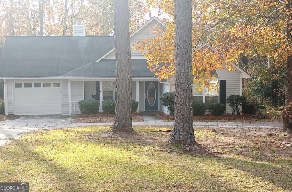 view of front of home featuring a garage and a front lawn