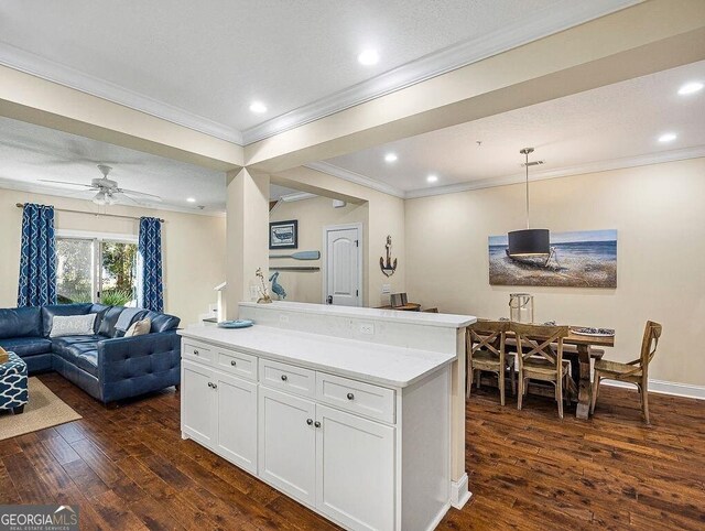 kitchen featuring sink, dark wood-type flooring, a breakfast bar, white cabinets, and appliances with stainless steel finishes