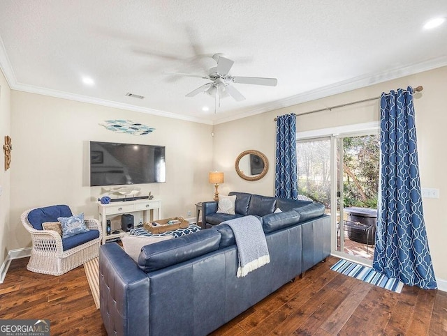 living room featuring ceiling fan, dark wood-type flooring, a textured ceiling, and ornamental molding