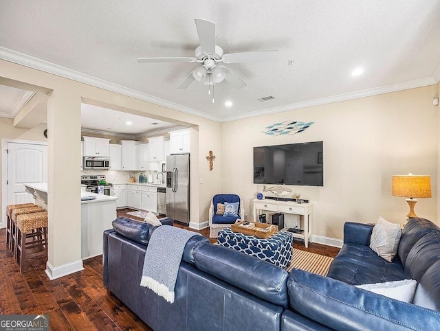 living room with ceiling fan, sink, dark wood-type flooring, and ornamental molding