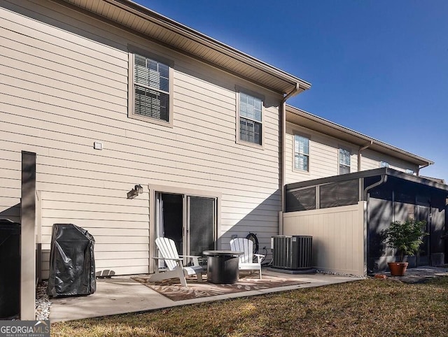 back of house with cooling unit, a patio area, and a sunroom