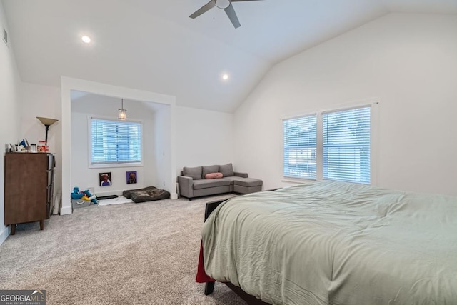 carpeted bedroom featuring multiple windows, ceiling fan, and vaulted ceiling