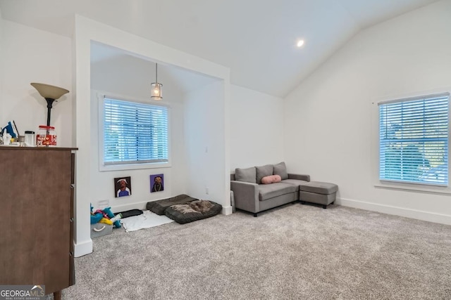 sitting room featuring carpet and lofted ceiling