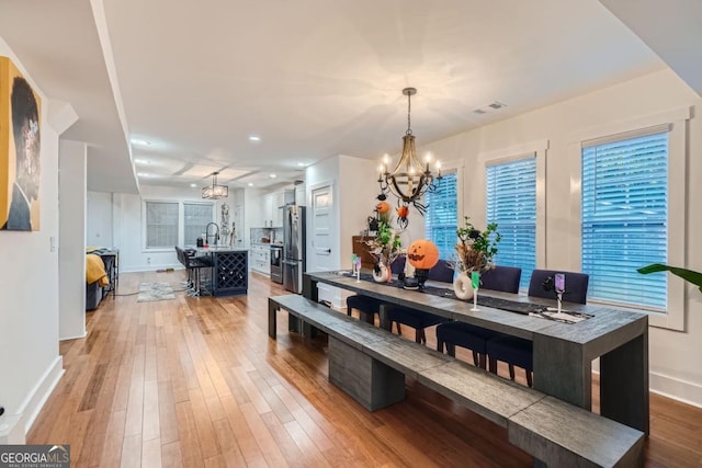 dining area with a chandelier and hardwood / wood-style flooring