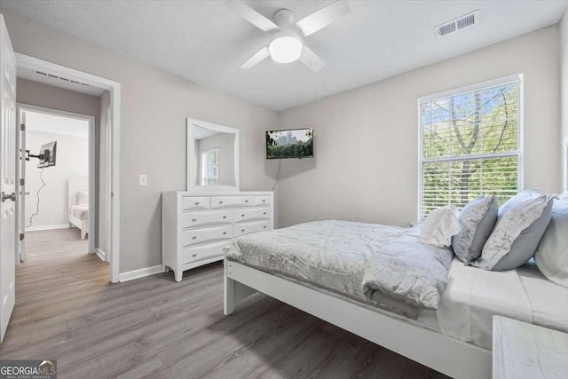 bedroom featuring ceiling fan and light hardwood / wood-style flooring