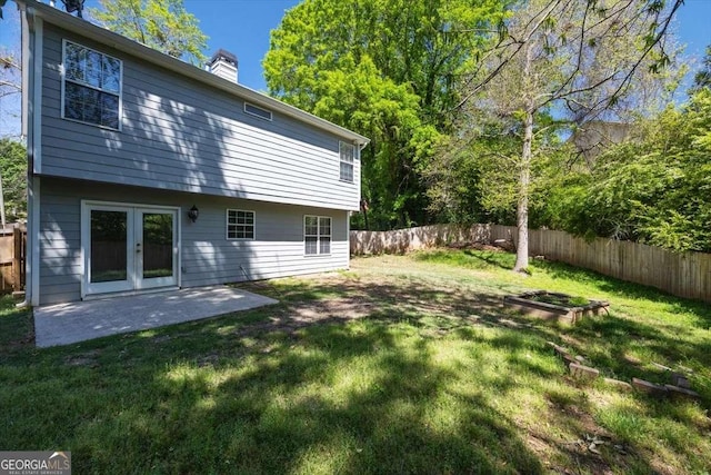 rear view of property with a lawn and a patio area