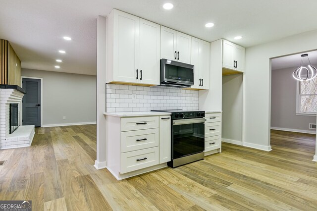 unfurnished living room featuring a healthy amount of sunlight, hardwood / wood-style floors, and a fireplace