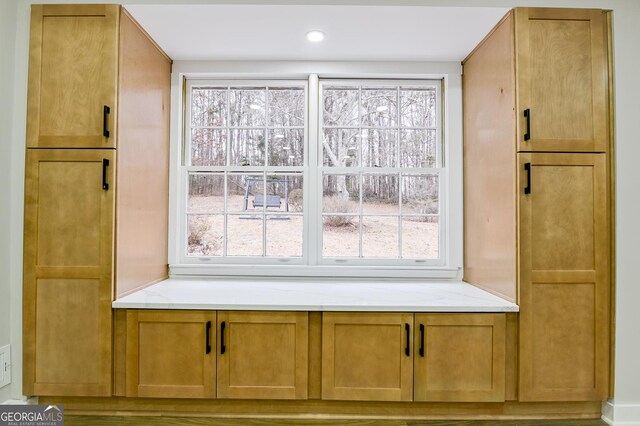 bathroom with a shower with door and sink