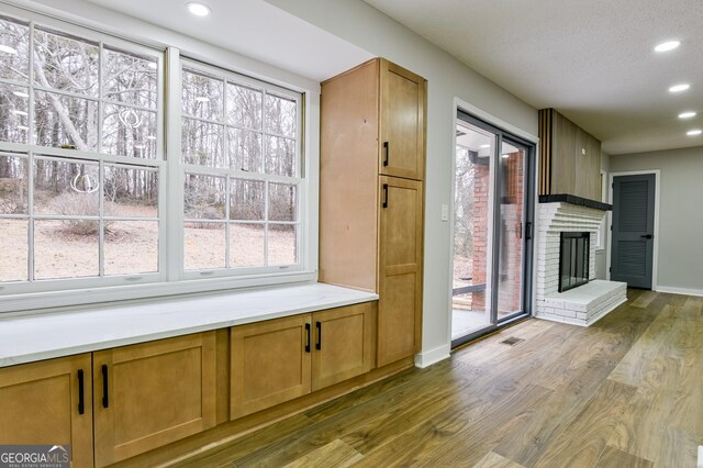 full bathroom with vanity, separate shower and tub, a textured ceiling, and toilet