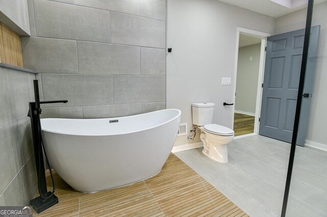 bathroom featuring shower / washtub combination and toilet