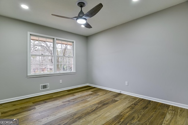 spare room with hardwood / wood-style flooring and ceiling fan