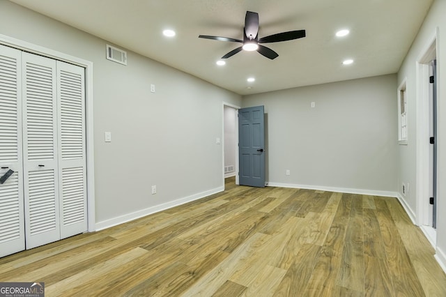 unfurnished bedroom featuring a closet, ceiling fan, and light wood-type flooring