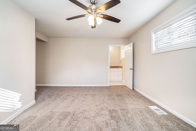 carpeted empty room with ceiling fan