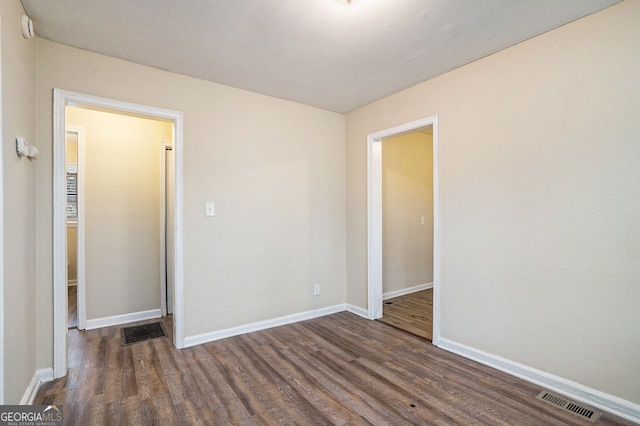 unfurnished room featuring dark hardwood / wood-style floors