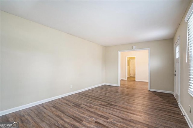 spare room featuring dark hardwood / wood-style flooring