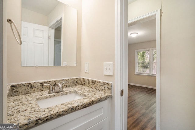 bathroom with hardwood / wood-style floors and vanity