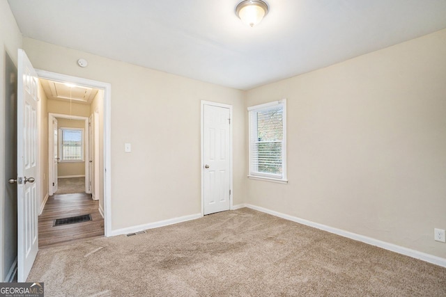 unfurnished bedroom featuring carpet and a closet