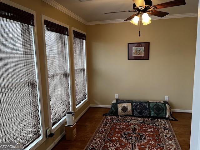 interior space with ceiling fan, dark hardwood / wood-style flooring, and ornamental molding