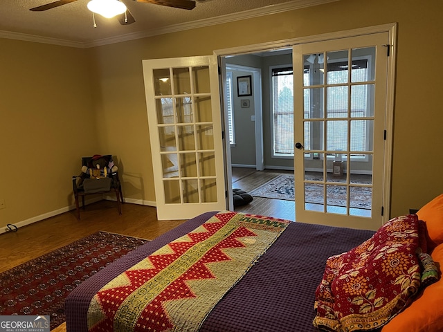 bedroom featuring ceiling fan, hardwood / wood-style floors, a textured ceiling, and ornamental molding