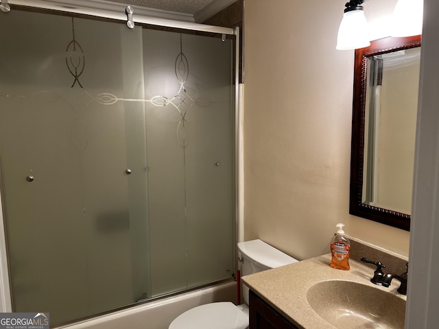 full bathroom featuring a textured ceiling, vanity, toilet, and bath / shower combo with glass door