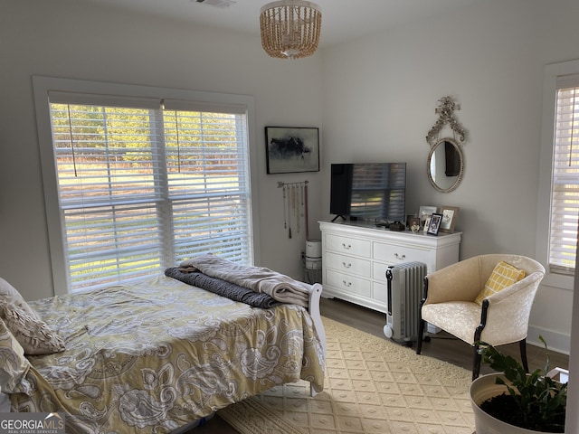 bedroom featuring multiple windows and light wood-type flooring