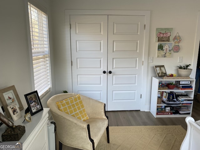 sitting room featuring plenty of natural light and dark hardwood / wood-style floors