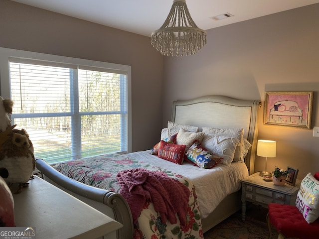 bedroom featuring a notable chandelier