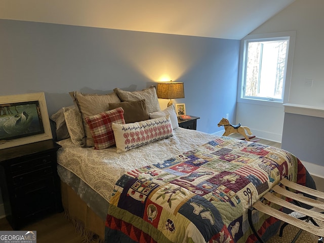 bedroom with hardwood / wood-style floors and vaulted ceiling