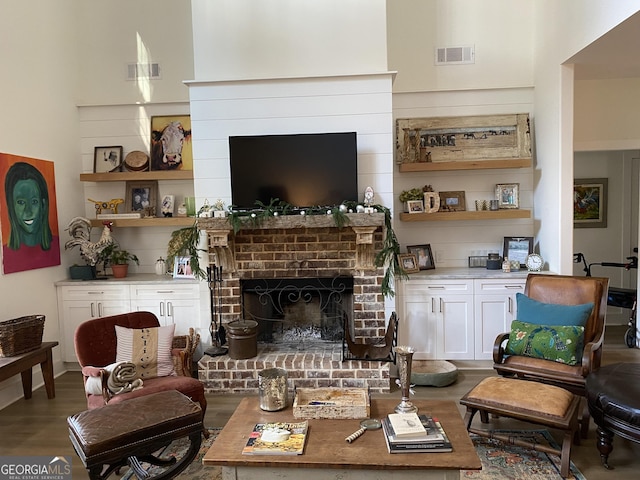 living room featuring wood-type flooring and a fireplace