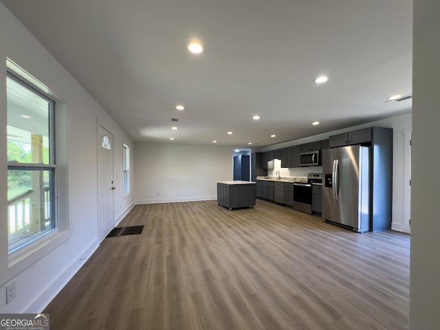 kitchen with light hardwood / wood-style flooring, stainless steel appliances, and sink