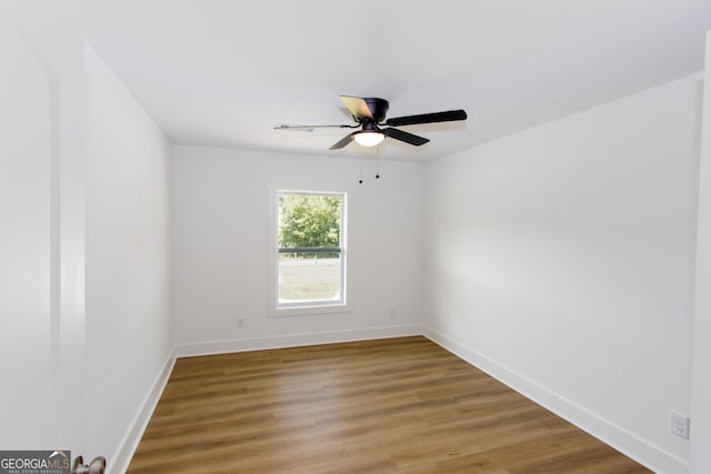 empty room featuring wood-type flooring and ceiling fan