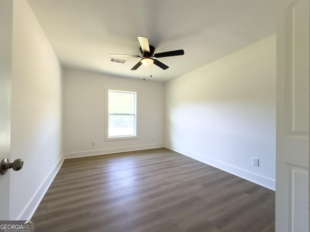 spare room featuring ceiling fan and dark hardwood / wood-style flooring