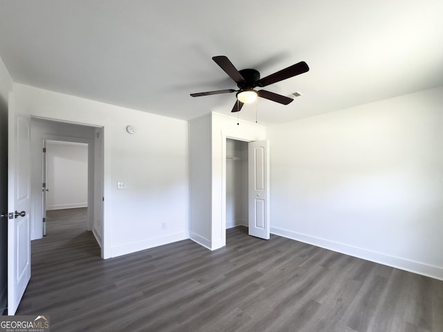 unfurnished bedroom with ceiling fan, dark hardwood / wood-style floors, and a closet