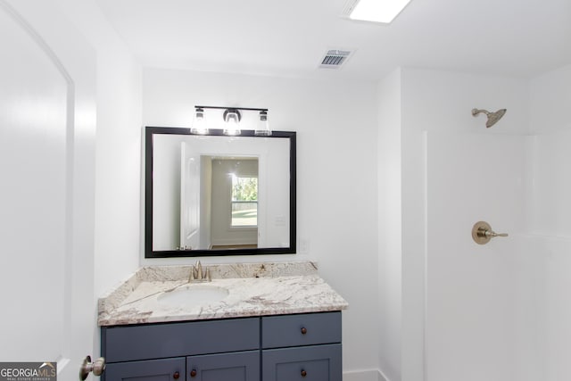 bathroom with vanity and walk in shower