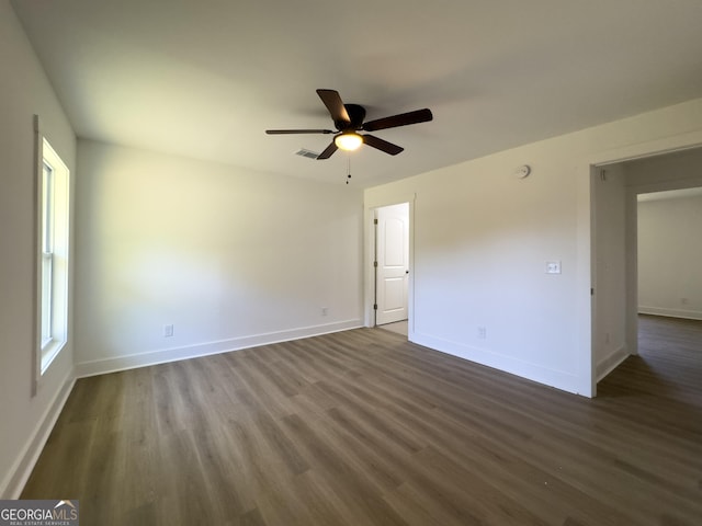 spare room featuring ceiling fan and dark hardwood / wood-style floors