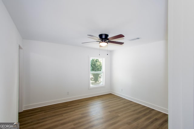 unfurnished room featuring dark hardwood / wood-style floors and ceiling fan