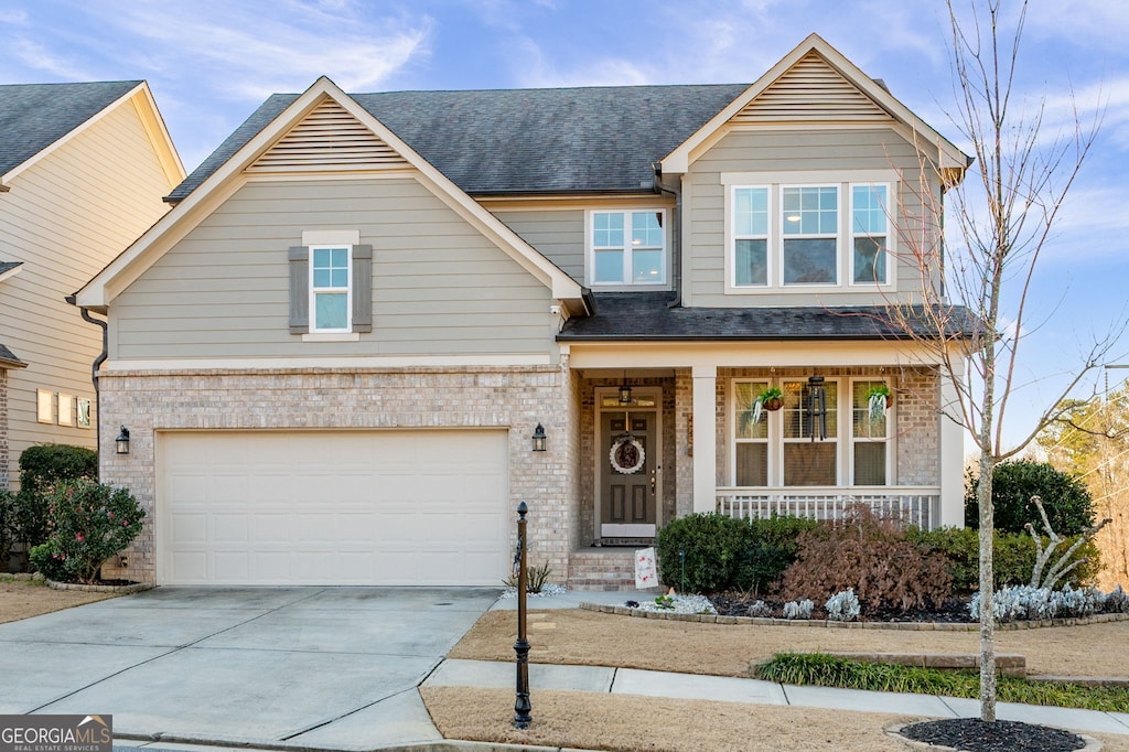 craftsman-style house featuring covered porch and a garage