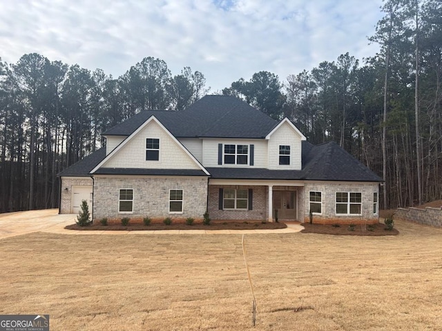 view of front facade featuring an attached garage, driveway, and a front yard