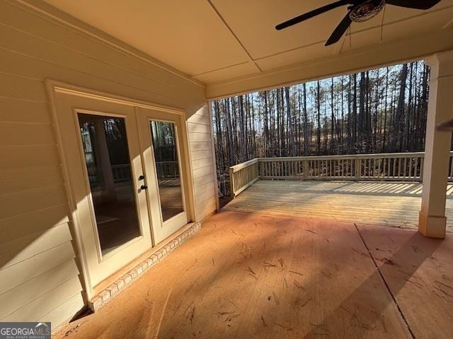 deck with a ceiling fan, french doors, and a patio